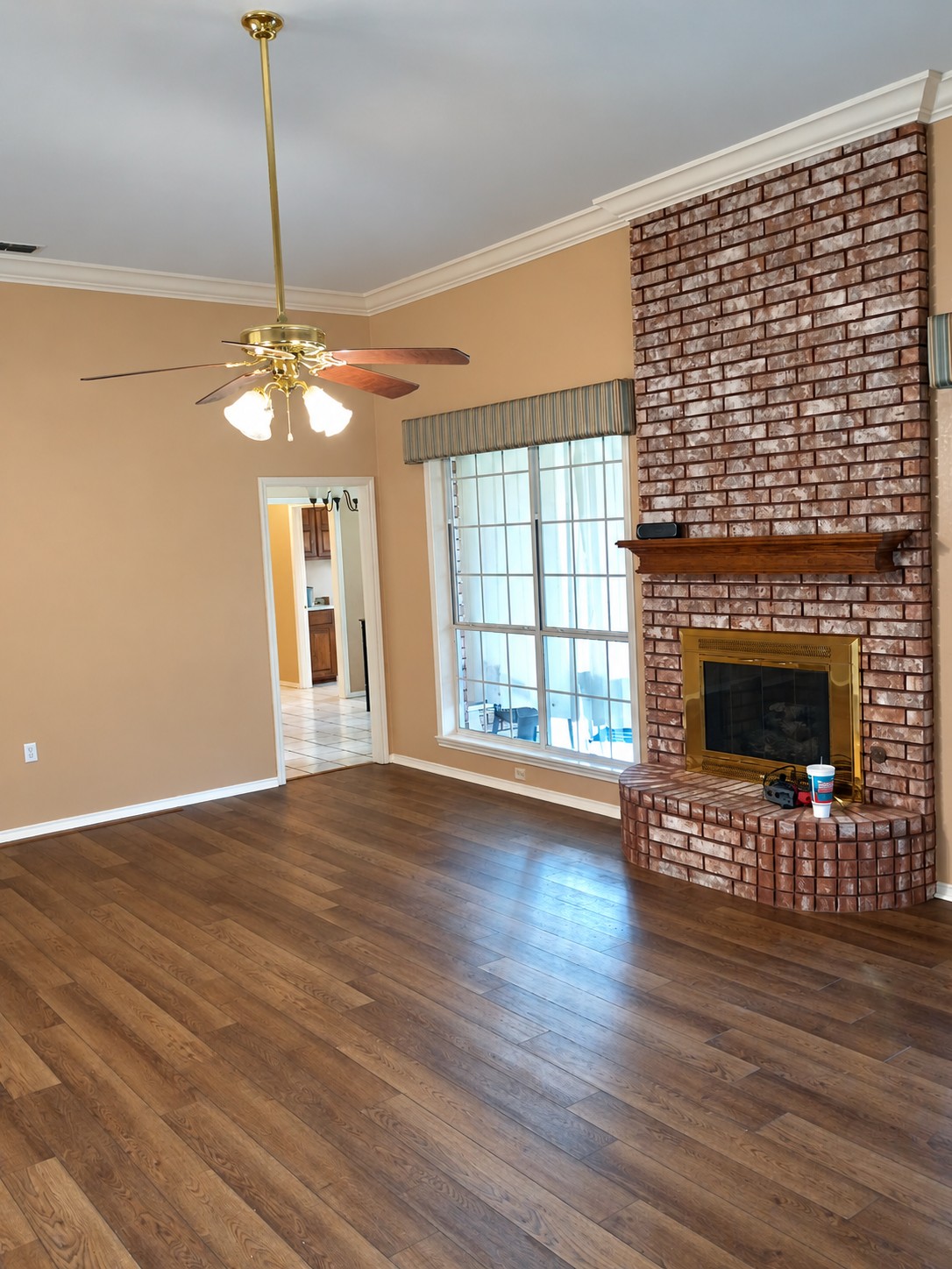 Beauté Royal living room project with wood-look flooring and brick fireplace